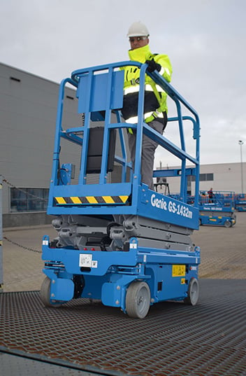Genie GS1932m - electric scissor lifts been loaded on to trailer